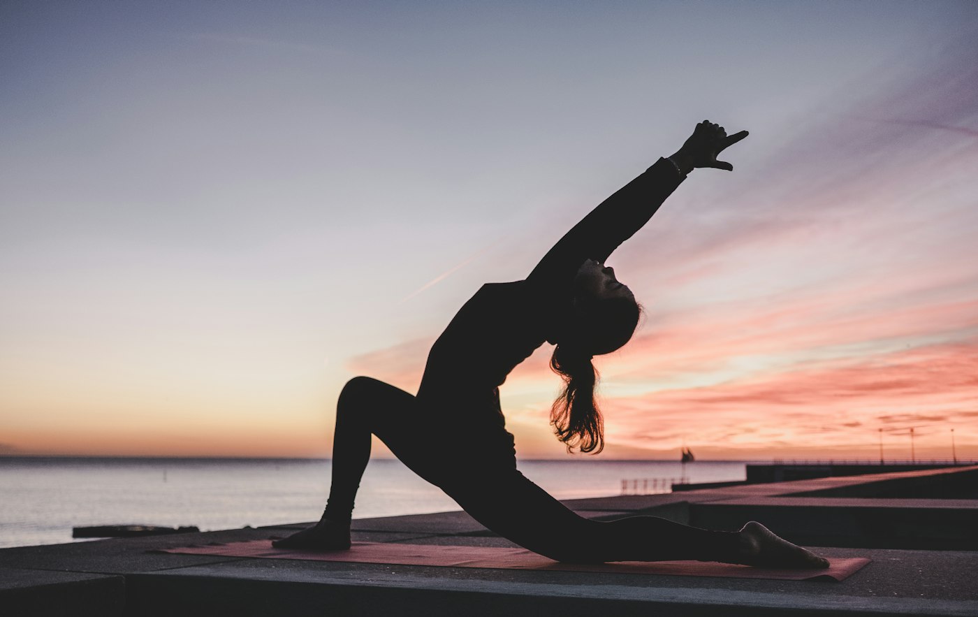 A mobility stretch outdoors at sunset
